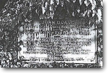 A photo of John Doane's tombstone. Words below John Doane are illegible.