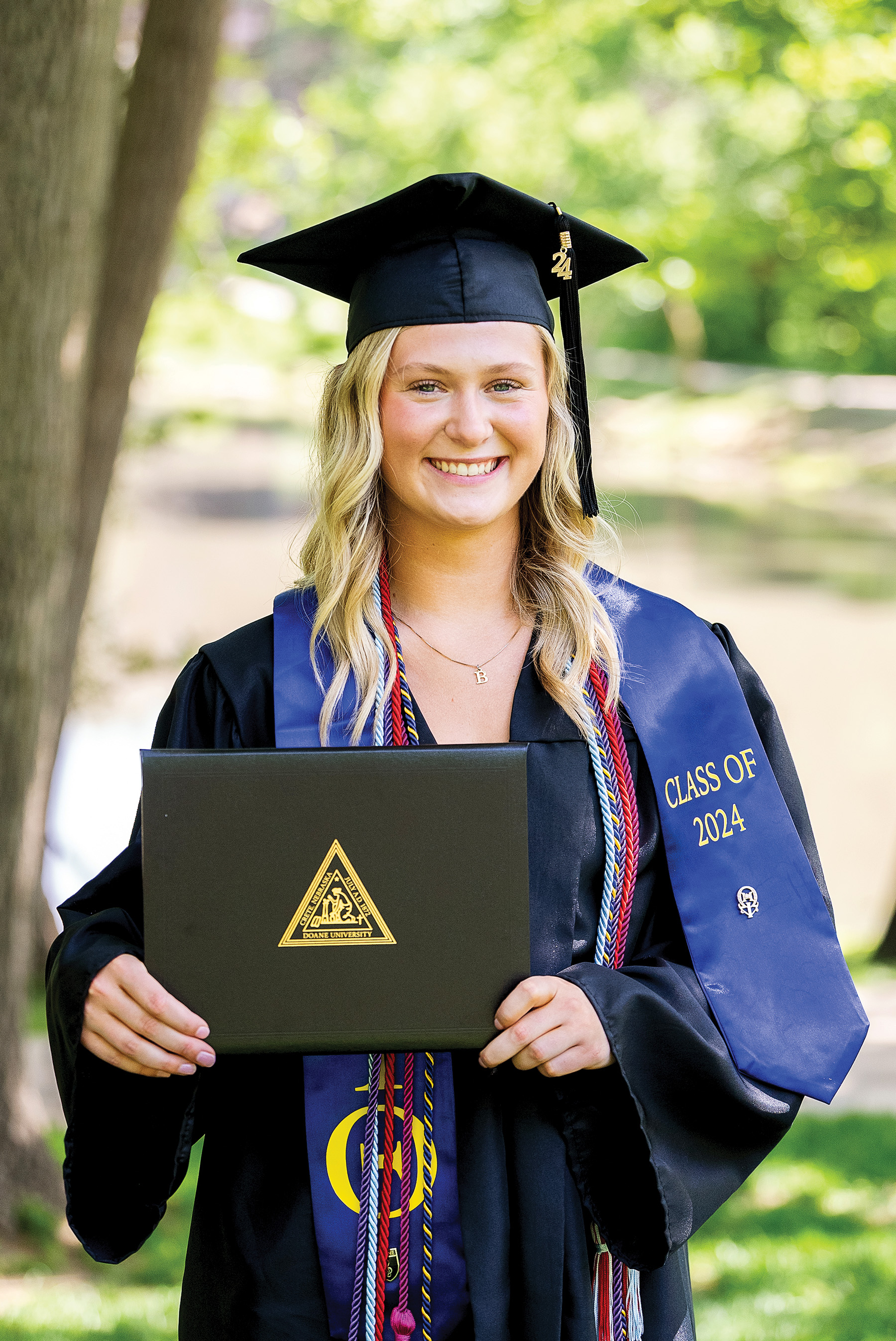 Blair Souchek ’24 stands holding her diploma.