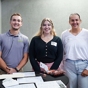 a candid shot in a Doane event, staff members standing at tables